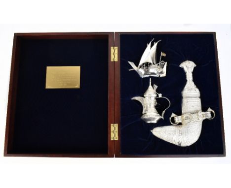 OMAN; a presentation silver set comprising Saidi Khanjar in scabbard, length 29cm, Dallah coffee pot and model of Dhow, in ve