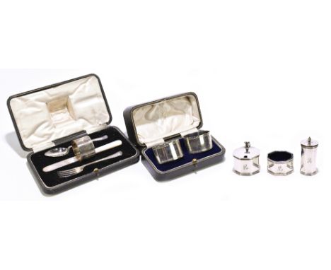 A hallmarked silver three piece cruet, with engraved initial ‘R’, Birmingham 1958, with a pair of silver napkin rings, and a 