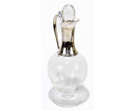 J. A. CAMPBELL; a modern hallmarked silver mounted glass claret jug and stopper with scroll handle, London 1998, height 30.5c