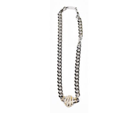 CHRISTIAN DIOR; a heavy vintage silver tone chain link necklace with gold and silver tone pendant, set with rhinestones, in f