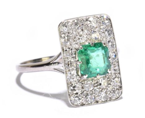 A good Art Deco emerald and diamond ring, the central square cut emerald weighing approx. 1.3cts within a platform of twenty-