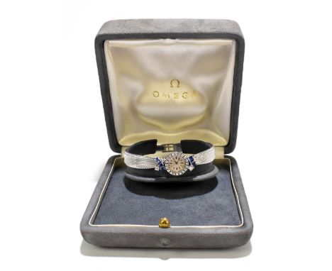 OMEGA; a lady's diamond and sapphire set 18ct white gold cocktail wristwatch, the baton dial surrounded by twenty small diamo