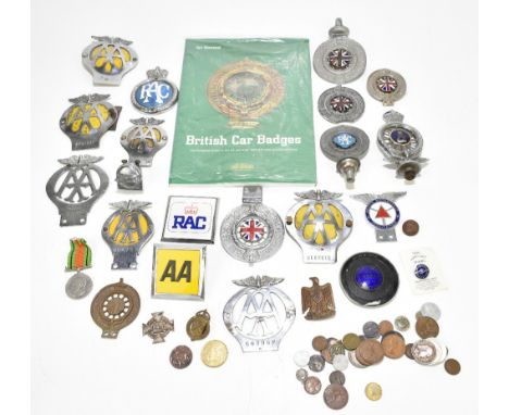 Nineteen various vintage car badges, including enamel examples, and a book relating to British car badges.