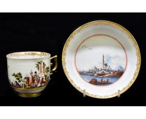 MEISSEN; a 19th century cup and saucer, the cup decorated with a continuous landscape of figures, boats and harbour, the plat