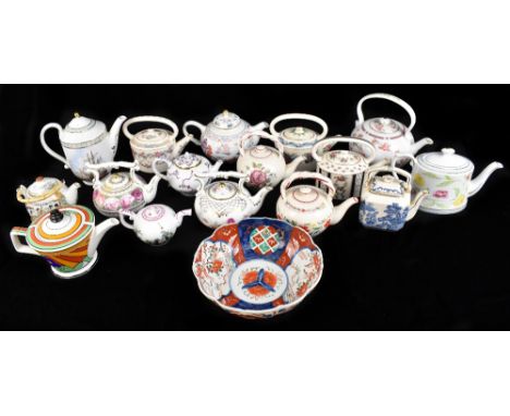 A collection of assorted teapots including various collectible reproduction examples, a Past Times example inspired by Claric