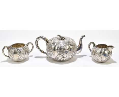 WANG HING; a Chinese 90 grade silver three piece tea set, comprising teapot with ivory insulators to the handle, milk jug and