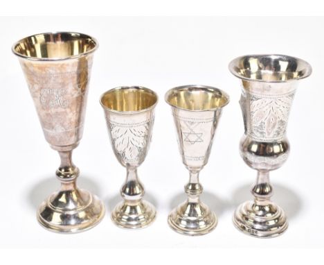 JUDAICA; four hallmarked silver kiddush cups, each with engraved detail, height of tallest 12cm, approx 3.5ozt/119gAdditional