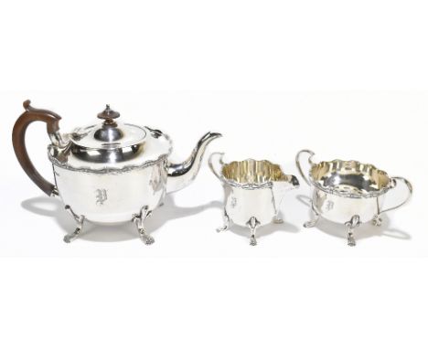 COOPER BROTHERS; a George V hallmarked silver three piece tea service with cast rim with engraved initial 'P' to body, Sheffi