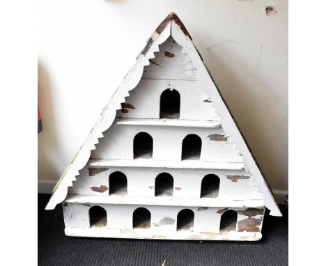 A white painted wood dovecote, of triangular form with wood tile roof and four tiers with ten apertures, height 111cm, with l