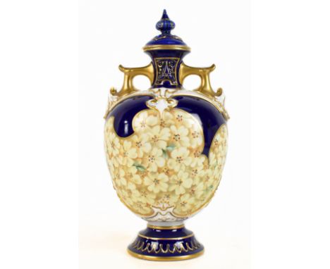 ROYAL WORCESTER; a twin handled pedestal vase and cover, with hand-painted floral decoration, blue printed marks to underside