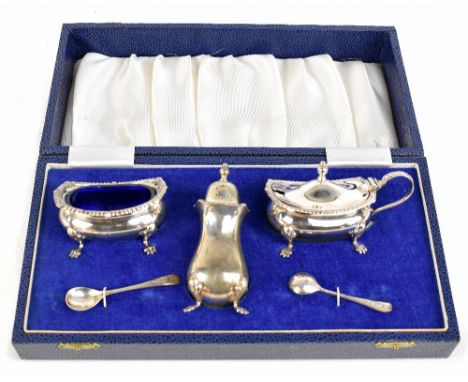 A hallmarked silver three piece cruet on paw shaped feet, Birmingham 1974, in fitted case 6ozt/191g.Additional InformationA f