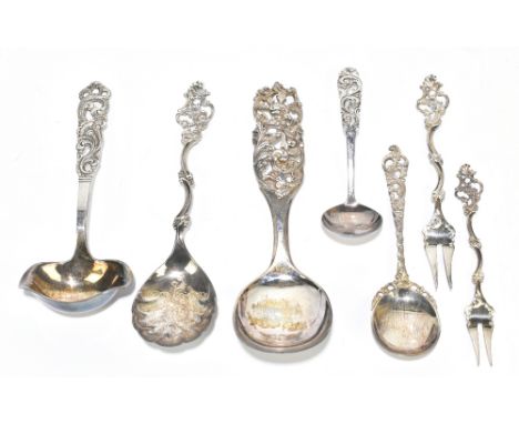 Seven Continental white metal serving spoons and forks, possibly Norwegian, each with a different cast and pierced floral han