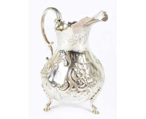 ROBERT HARPER; a Victorian hallmarked silver cream jug of baluster form with repoussé floral and scrolling decoration with en