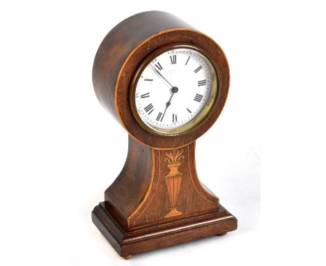 J.H. PERRY OF SHEFFIELD; an Edwardian inlaid mahogany timepiece, the circular enamel dial with Roman numerals, raised on four