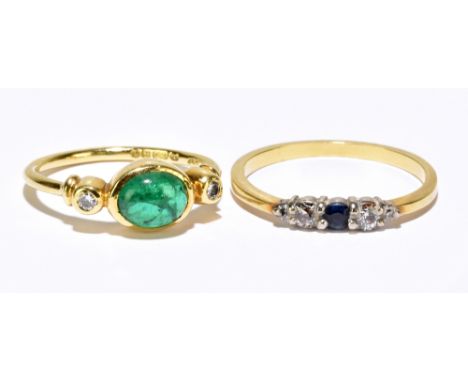 An 18ct yellow gold cabochon emerald and twin diamond collet set ring, size K, approx. 2.7g, and a yellow metal dress ring, s