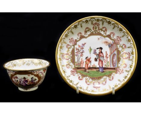 MEISSEN; an early 18th century tea bowl and saucer with Chinoiserie decoration, the tea bowl with floral sprays to the centre