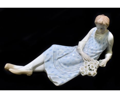 MEISSEN; a 20th century reclining figure holding a bouquet of flowers, painted marks to base, impressed 166 and incised 152, 