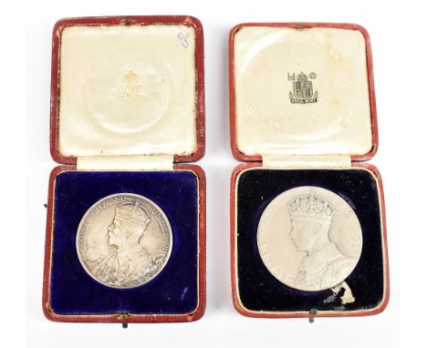 A King George V Silver Coronation medallion, one side decorated with a portrait of the King, the other with a portrait of Que
