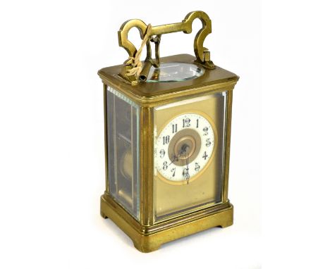 A late 19th century brass carriage timepiece, the brass dial with an enamelled Arabic numeral chapter ring and movement strik