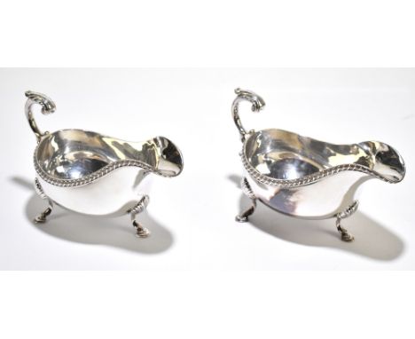 ROBERTS &amp; BELK; a pair of hallmarked silver sauce boats, with flying scroll handles, Sheffield 1973, 24ozt / 764g (2)Addi