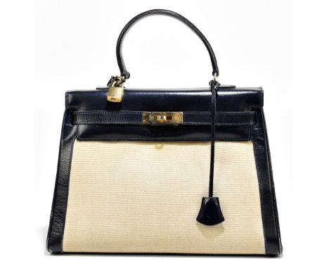 A vintage 1950s canvas and box blue leather handbag in the style of a Hermès Kelly 32 bag, with gold tone hardware closure, p