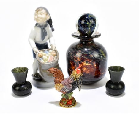 ROYAL COPENHAGEN; a figure of a boy holding a bag of fruit, height 16cm, together with a Mdina glass scent bottle and stopper