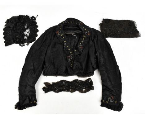 A Victorian short black silk long sleeved jacket, embellished with embroidery and black jet beads and lace, a black silk coll