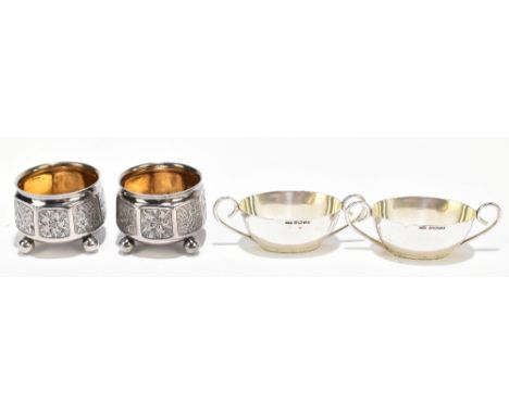 GEORGE UNITE; a pair of Victorian hallmarked silver salts, decorated with panels of flowers, on four ball feet, Birmingham 18