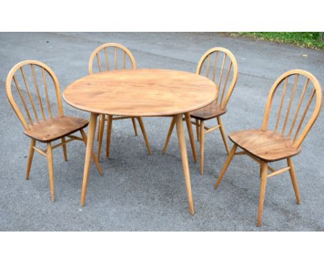 ERCOL; an oval dining table and four Windsor type chairs, the table height 73cm, length 100cm, chair height 86cm (5).Addition