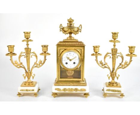 A late 19th century French gilt brass and alabaster clock garniture, the clock with urn surmount above the circular painted e