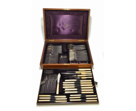 A late Victorian ninety-six piece part canteen of plated cutlery, including ivory handled and steel bladed knives, in an oak 