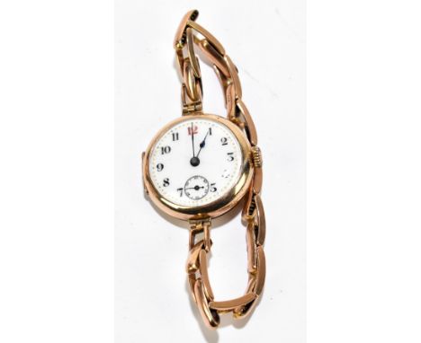 A lady's 9ct gold wristwatch, the white enamel dial with Arabic numerals and subsidiary seconds, the case stamped 9K and also