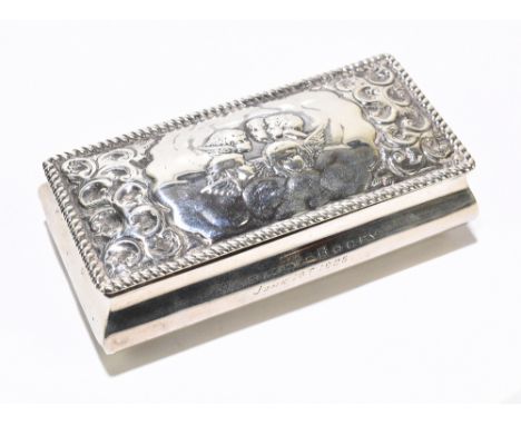 An Edwardian hallmarked silver trinket box, with Reynold's angels decorated lid, Birmingham 1904, 2.4ozt / 74g, length 100cmA