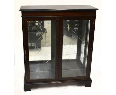 A reproduction mahogany display cabinet, with a pair of glazed doors enclosing shelves, raised on bracket feet, width 96cm, h