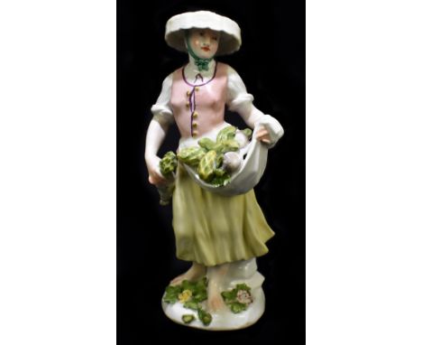 MEISSEN; a mid 18th century figure of a vegetable seller, circa 1750, modelled by Johann Frederick Eberline, painted mark to 