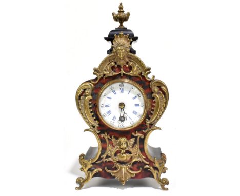 A late 19th century French ebonised simulated Boulle work and brass mounted mantel clock with Roman numerals to the white ena