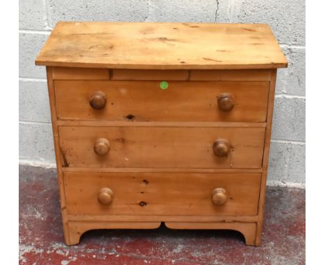 A pine chest of three long drawers with slightly bowfronted top and raised on integral bracket feet, width 84cm.