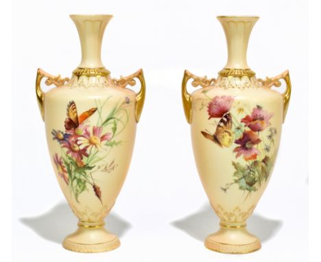 ROYAL WORCESTER; a near pair of twin handled pedestal blush ivory vases, decorated with butterflies and floral sprays, number