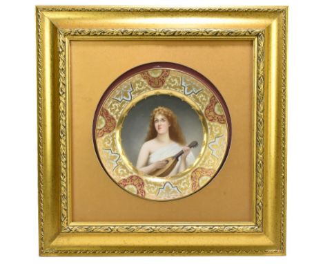 OLD VIENNA; a late 19th century cabinet plate, hand painted to the centre representing a maiden playing the lute inside gilt 