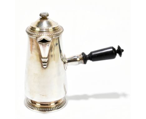 A 19th century French white metal chocolate pot, the hinged lid with a hinged finial, turned ebony handle, on beaded circular