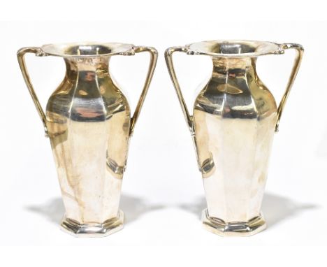 GOLDSMITHS &amp; SILVERSMITHS COMPANY LTD; a pair of Edwardian hallmarked silver twin handled octagonal vases, London 1909, h