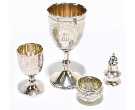 A George V hallmarked silver goblet with engraved detail, height 15.5cm, and a smaller goblet, a silver pepper and embossed s
