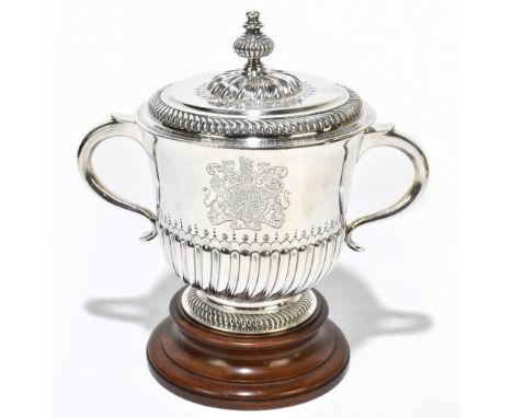 CARRINGTON &amp; CO; a George V hallmarked silver twin handled lidded trophy cup, the cover with a single knop finial with ga