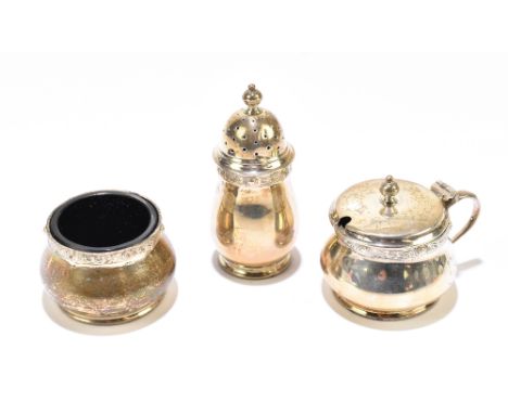 ADIE BROS; a hallmarked silver three piece condiment set, with Celtic strapwork detailing, Birmingham 1958, 3.4ozt/107g, (3).