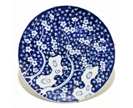 A late 19th century Chinese blue and white wall charger, decorated with prunus flowers, diameter 45.5cm.Additional Informatio