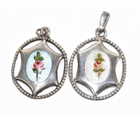 CHARLES HORNER; a near pair of sterling silver and floral painted enamel decorated pierced oval pendants, both marked sterlin