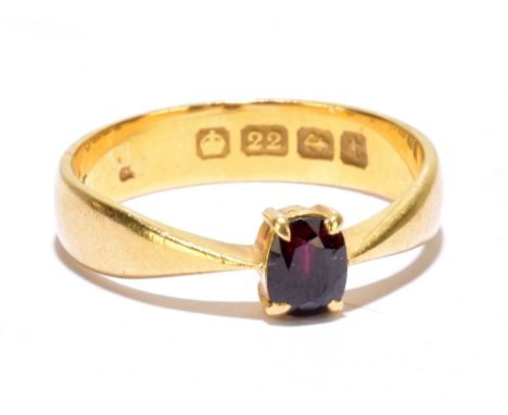 A 22ct yellow gold ring with four claw set oval garnet, size M, approx. 3.5g.Additional InformationSome abrasions to the surf