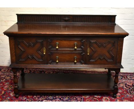 WARING &amp; GILLOW; a 1920s oak sideboard in the Jacobean style, with carved gallery back above two central drawers flanked 