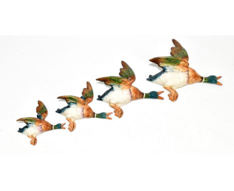 BESWICK; a family of four flying mallard wall plaques, measurements of largest example 27 x 25cm, (4).Additional InformationL