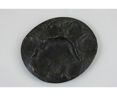 Rowland Ward, a bronze oval disc with large animal paw impression, signed on back Rowland Ward, London, 17cm by 15cm